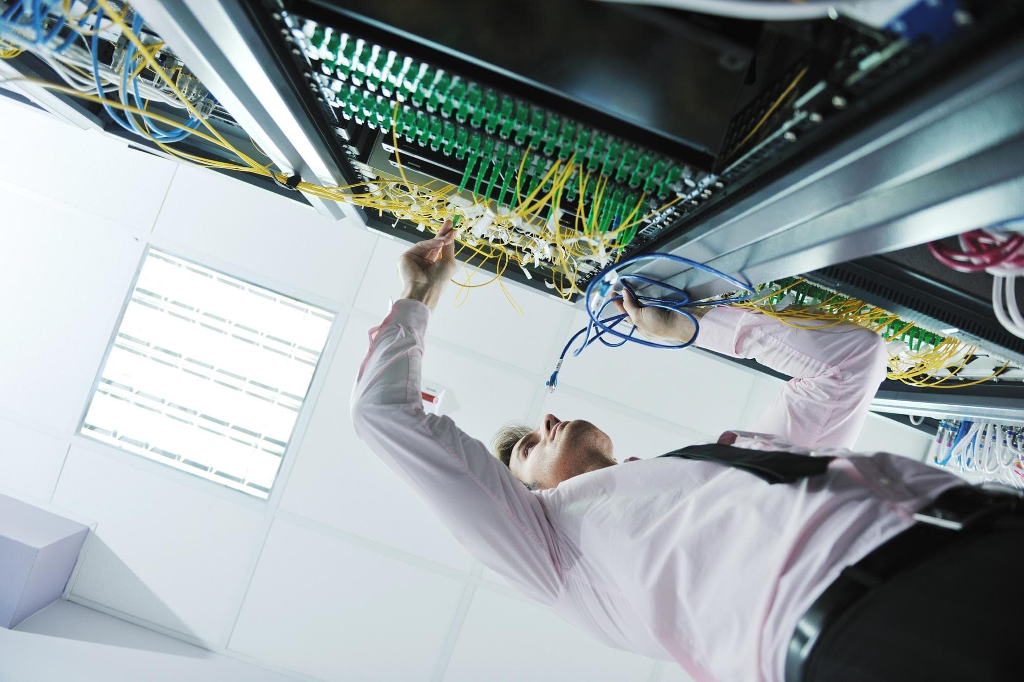 Network engineer working in a data center to keep store systems online